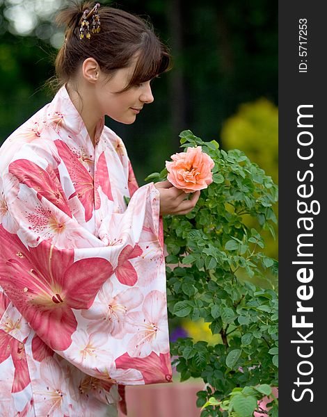 Girl in a pink yukata with rose. Girl in a pink yukata with rose