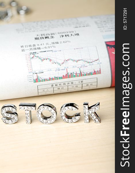 Text of â€˜stockâ€™ with newspaper about stock