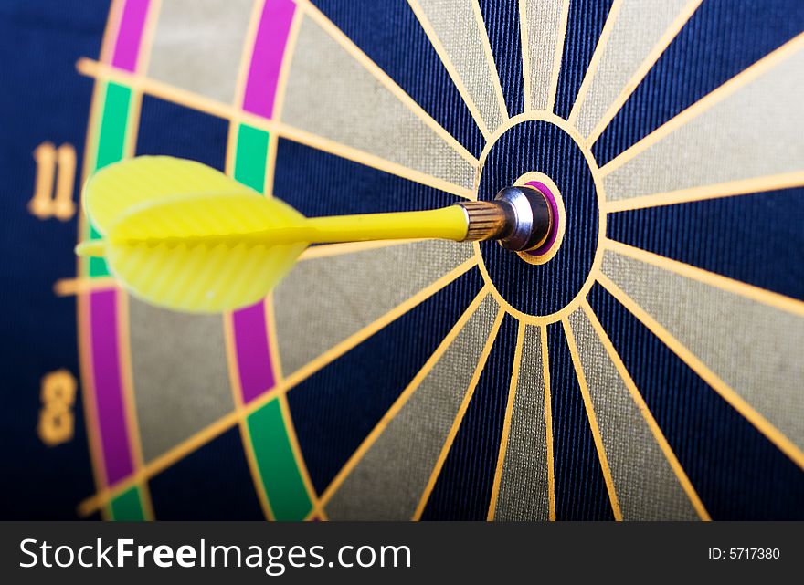 A magnetic dart board with darts at the center (bullseye)