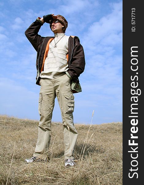 Man tourist on background of blue sky