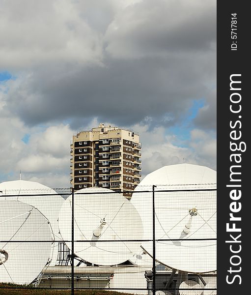 Shot of some satelitte dishes and skyscraper against the skyline. Shot of some satelitte dishes and skyscraper against the skyline
