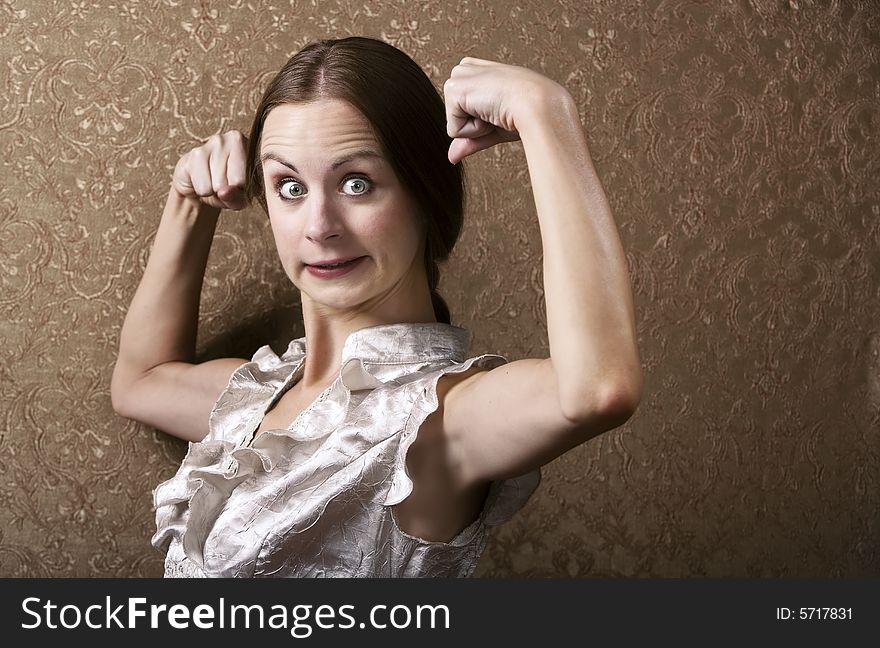 Pretty Young Woman Posing with Flexed Biceps. Pretty Young Woman Posing with Flexed Biceps