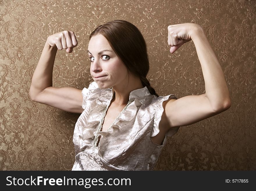 Portrait of a Pretty Young Woman Flexing Her Biceps