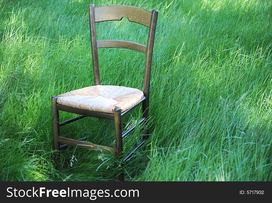 Chair isolated in a field of green grass.