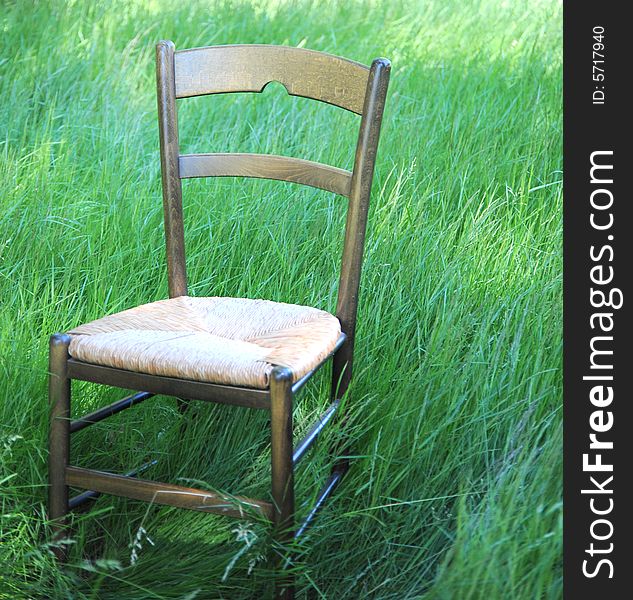 Chair isolated in a field of green grass.