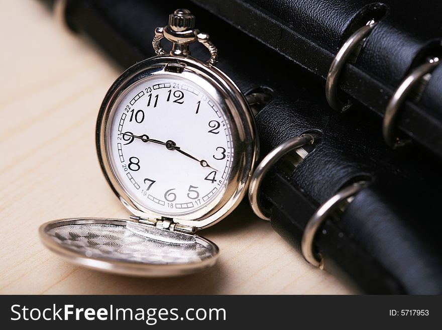 Pocket watch with balck notebook. Pocket watch with balck notebook