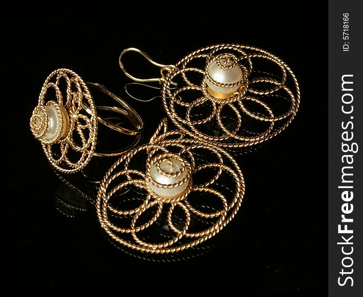 Jewelry from gold decorated by pearls. Jewelry from gold decorated by pearls