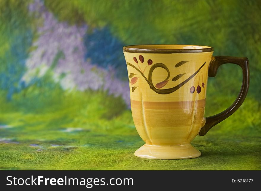 Coffee cup on green background