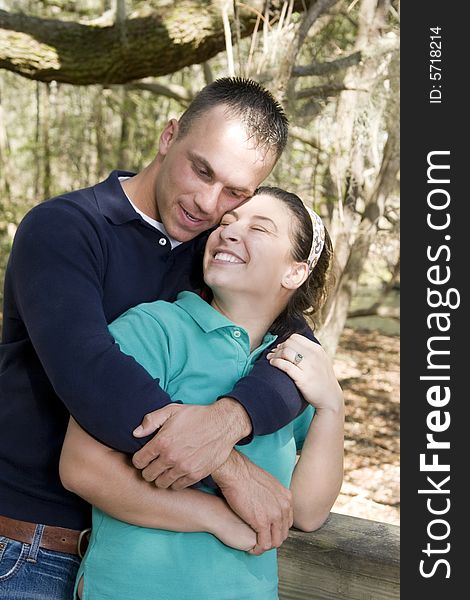 Young couple embracing in outdoor setting