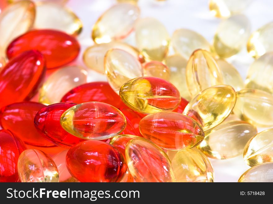 Yellow and red vitamin pills background. Yellow and red vitamin pills background