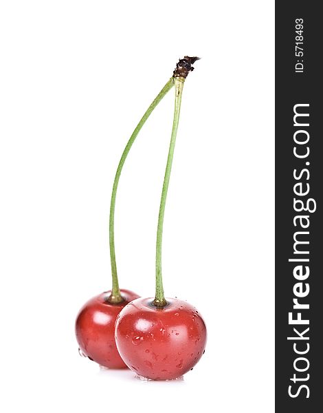 Two cherries against white background