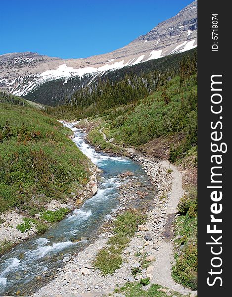 River valley and snow mountains in glacier national park, USA