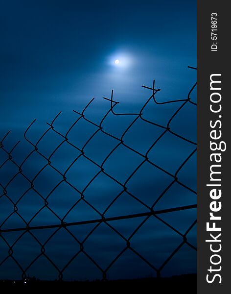 Garden fense on full moon in clouds. Windy weather. Garden fense on full moon in clouds. Windy weather.