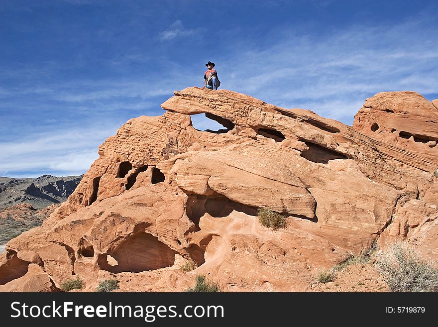 Lonely cowboy searching the landscape in Valley of Fire National Park Nevada