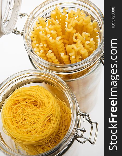 Pasta in glass can on a white background