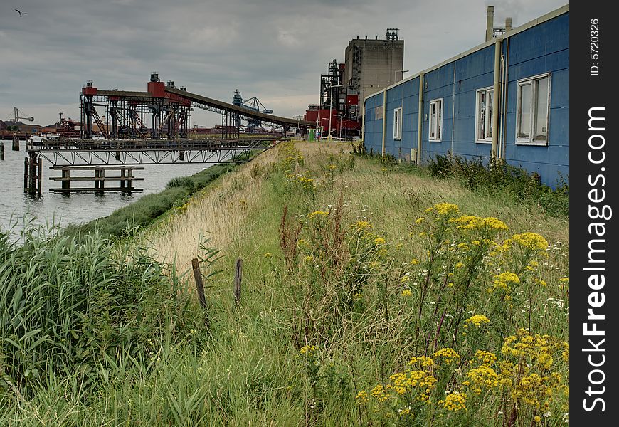 A factory with a old supermarket in front in one of the ports of Rotterdam, HDR image. A factory with a old supermarket in front in one of the ports of Rotterdam, HDR image