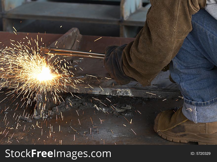 A shipyard steel worker burning steel. A shipyard steel worker burning steel