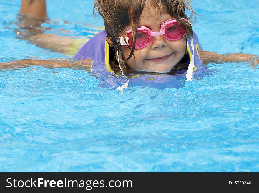 A young girl playing in pool. A young girl playing in pool