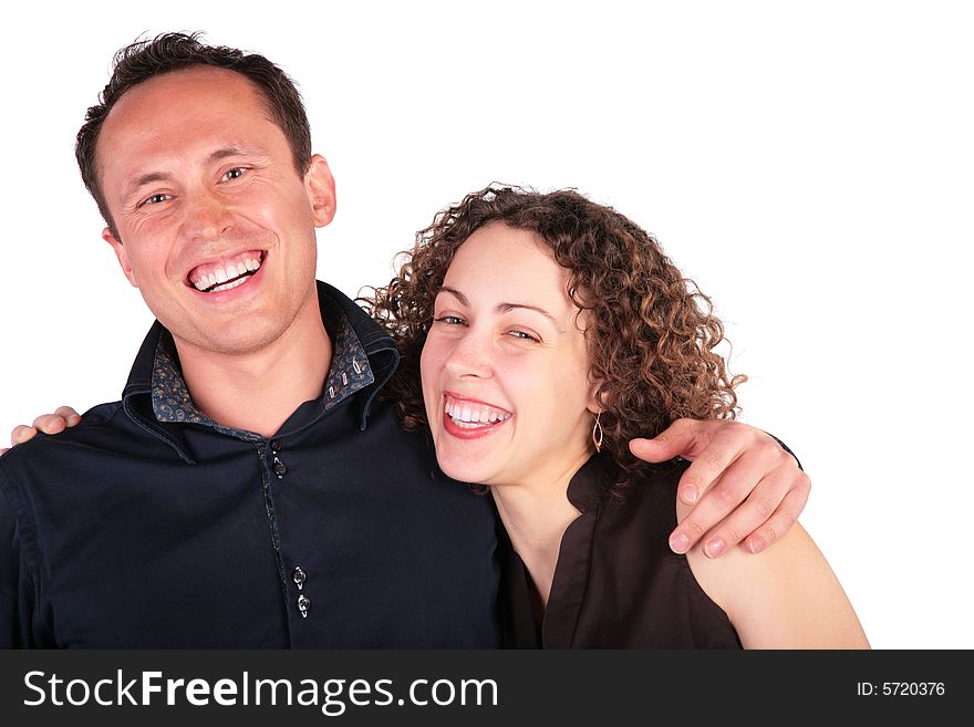 Young pair embraces and laughs loudly on white