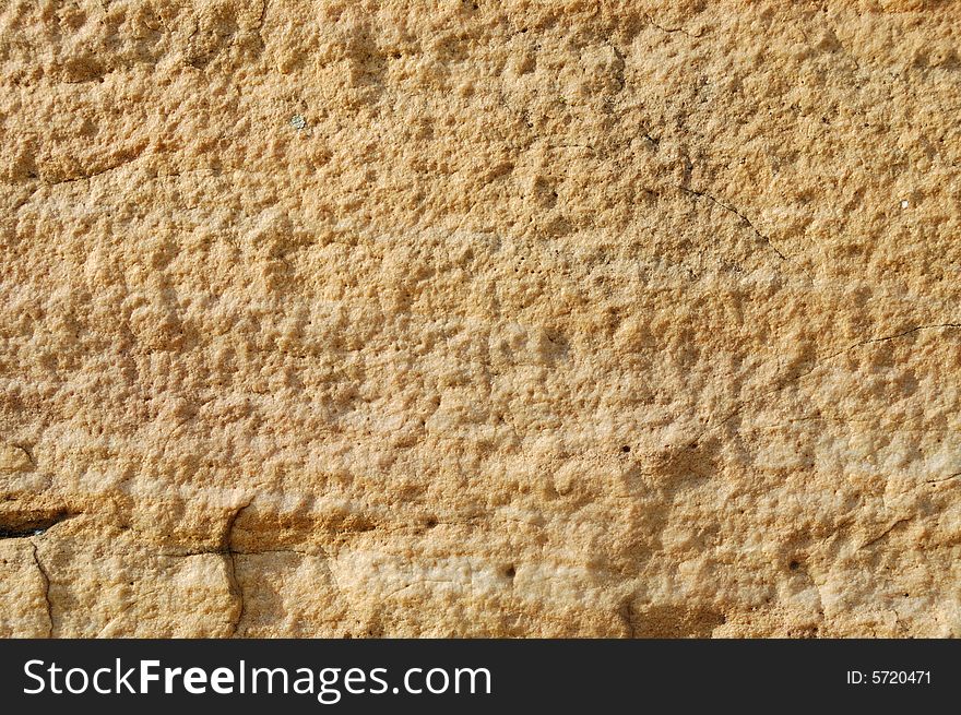 Light yellow stone textured background with cracks. Light yellow stone textured background with cracks