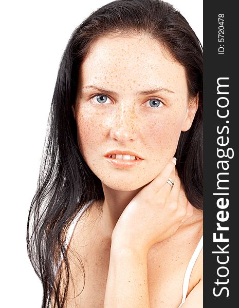 Portrait of a beautiful brunette woman with light grey eyes and freckles on her skin. Portrait of a beautiful brunette woman with light grey eyes and freckles on her skin