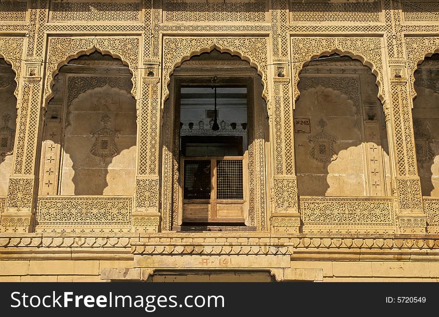 Rich Jaisalmer haveli. Detail of a full carved and sculpted yellow sand stone mogul style dwelling with pillars and wide balcony constructed at the time of Maharajahs by a rich merchant. Rajasthan, India. Rich Jaisalmer haveli. Detail of a full carved and sculpted yellow sand stone mogul style dwelling with pillars and wide balcony constructed at the time of Maharajahs by a rich merchant. Rajasthan, India.