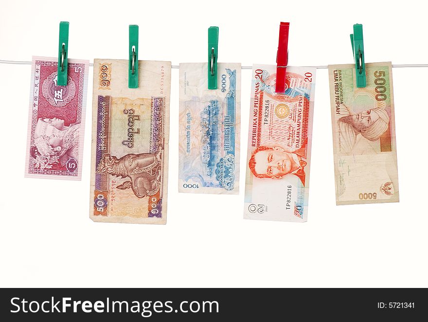 Banknotes of China, Myanmar(Burma),Cambodia, Philippines, Indonesia on a rope. Attached with clothespins. Concept for Money laundering or distant travel in Asia. Banknotes of China, Myanmar(Burma),Cambodia, Philippines, Indonesia on a rope. Attached with clothespins. Concept for Money laundering or distant travel in Asia