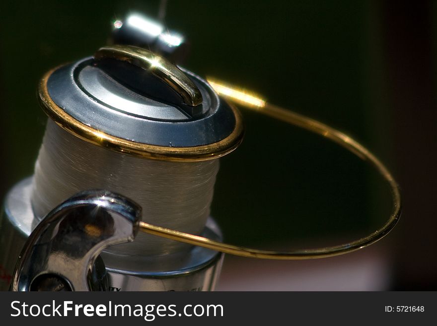 Fishing reel in the sun and ready to go.