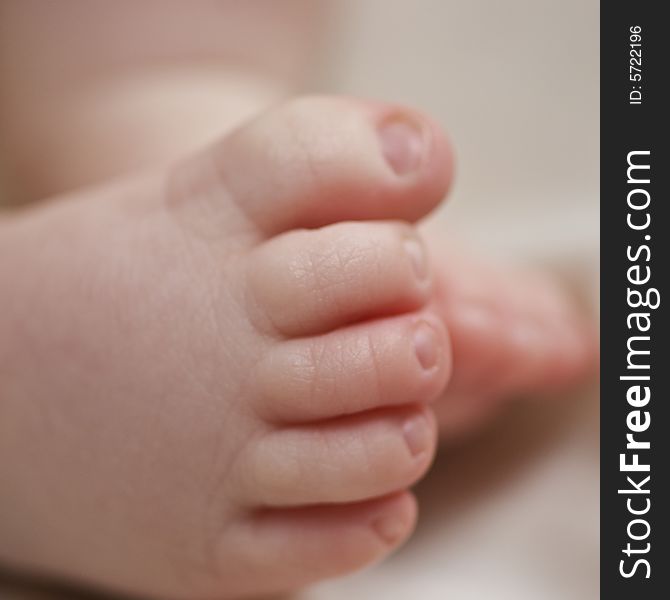 Soft focus close up of baby's foot against white background. Soft focus close up of baby's foot against white background