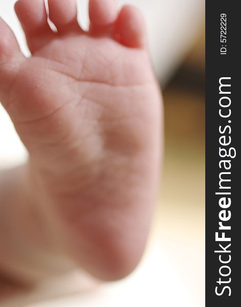 Soft focus close up of baby's foot against blurred background. Soft focus close up of baby's foot against blurred background