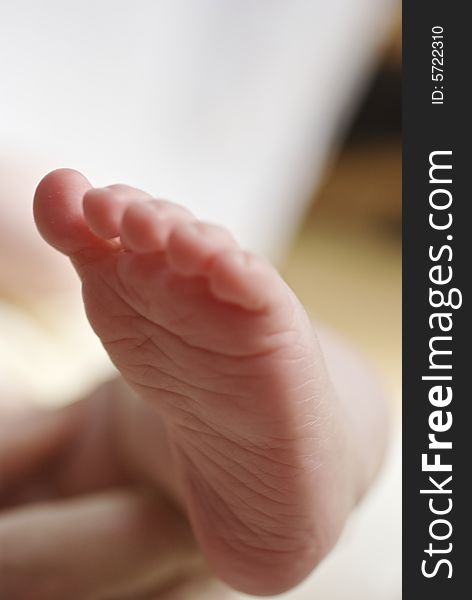 Soft focus close up of baby's foot against blurred background. Soft focus close up of baby's foot against blurred background