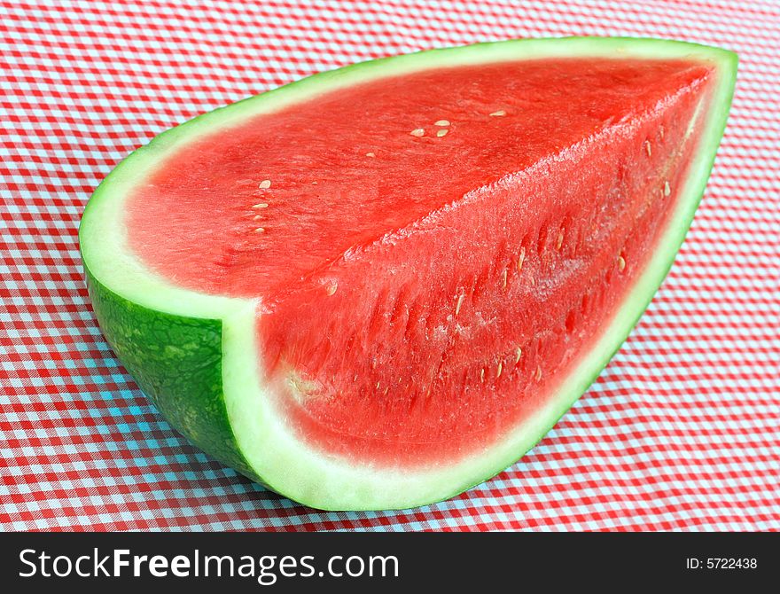 Fresh, juicy watermelon on a red check background.