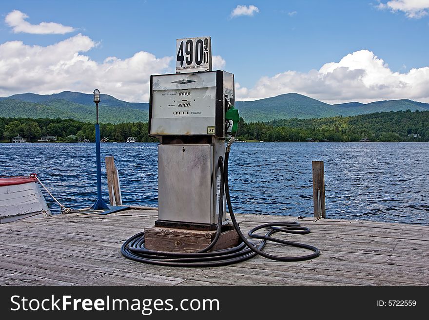 Gas station at water side for boats with mountains and forest on the background. Gas station at water side for boats with mountains and forest on the background