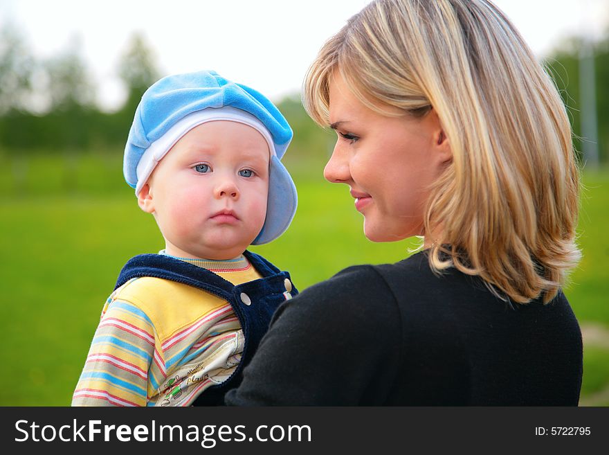 The portrait mother with son on hands