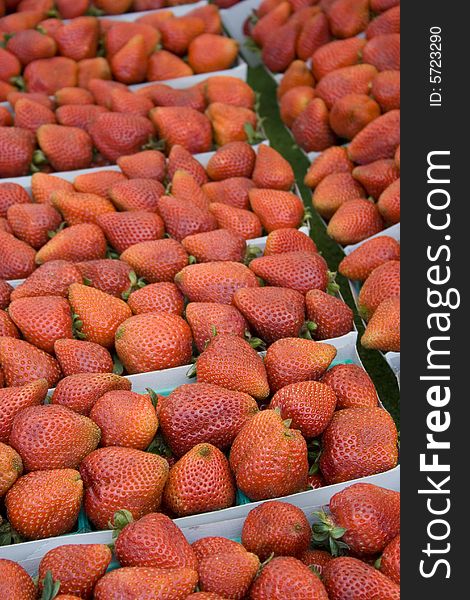 Fresh strawberries in baskets at local farmers' market