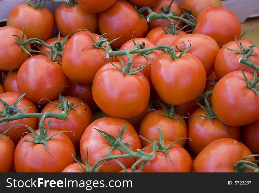 Red tomatoes with stems at the local farmers' market