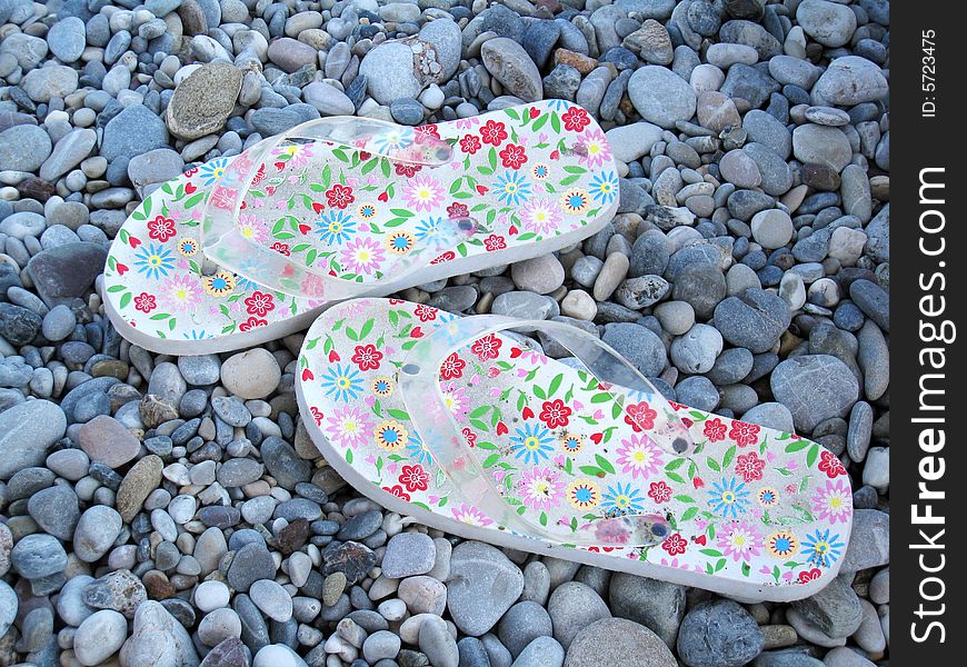 Flip flops on a pebble beach in summer. Flip flops on a pebble beach in summer