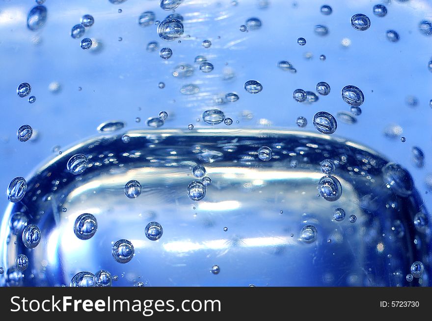 Blue water with bubbles close-up shot