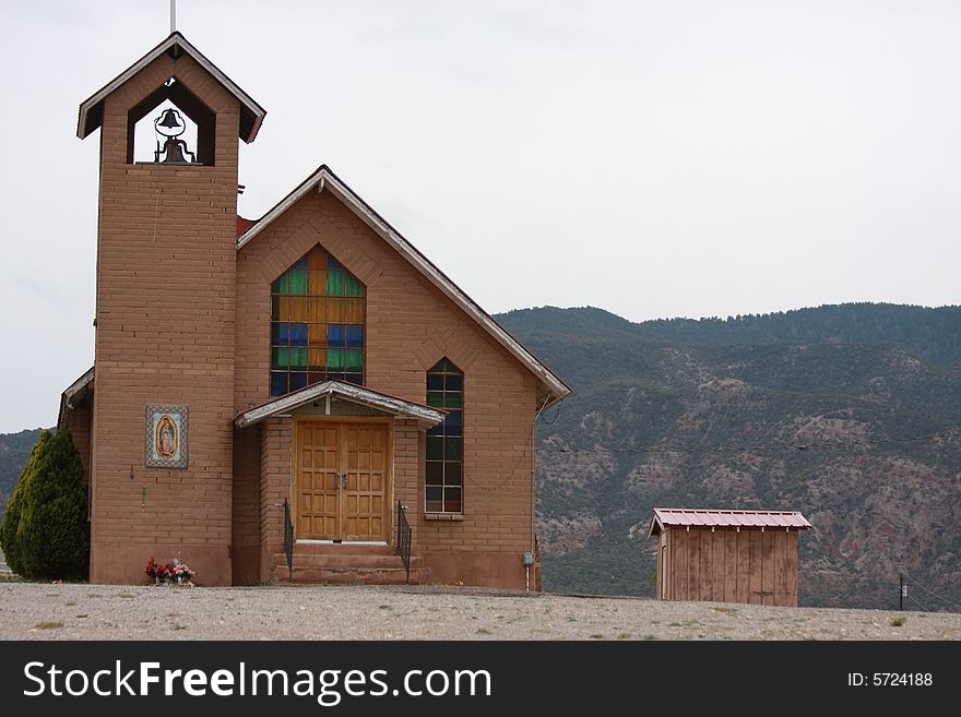 Church in the desert overshadows little shack. Church in the desert overshadows little shack
