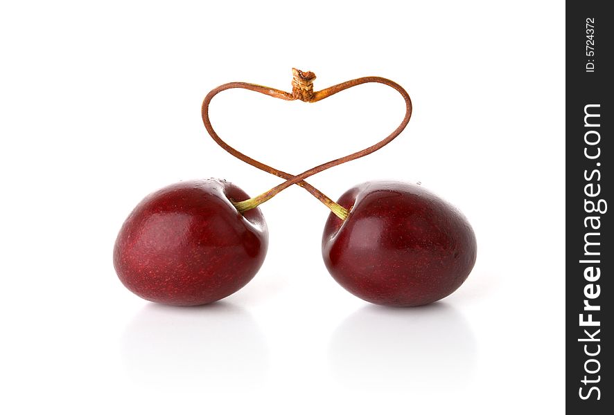 Two cherries bent in the form of heart. Two cherries bent in the form of heart