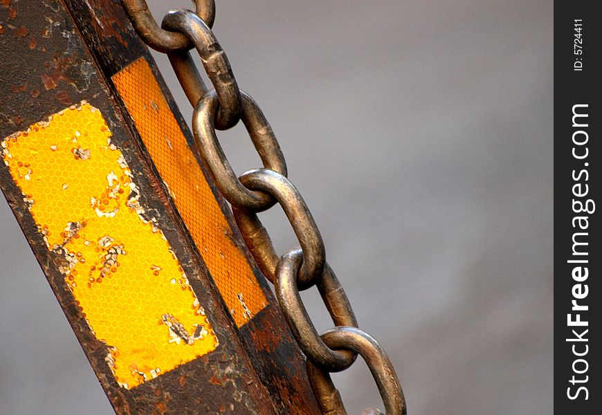 A glimpse of a chain hang down a pole