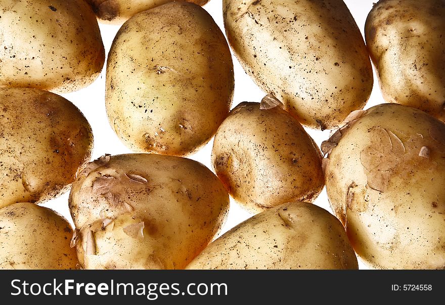 Young potatoes lying on the shiny background. Young potatoes lying on the shiny background