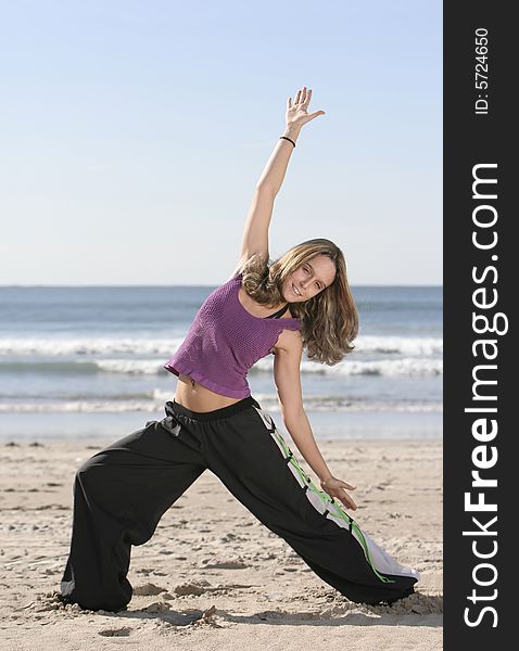 Woman stretching at the beach