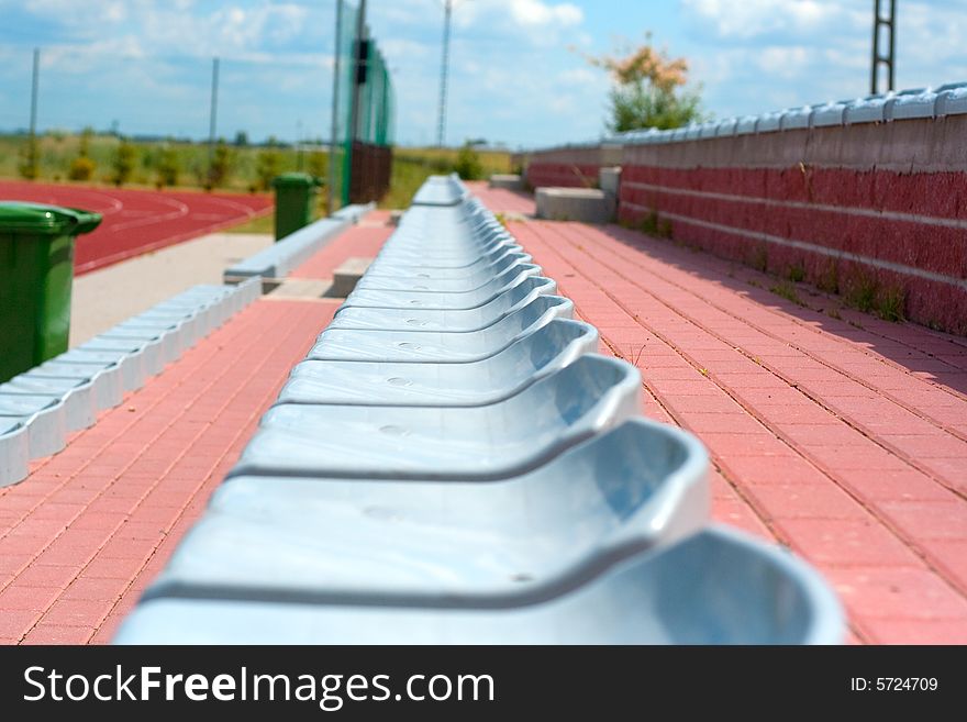 The lines of plastic chairs on sport stadium