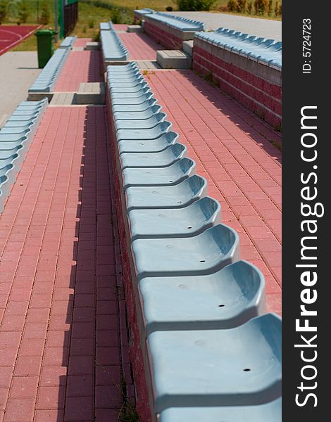 The lines of plastic chairs on sport stadium