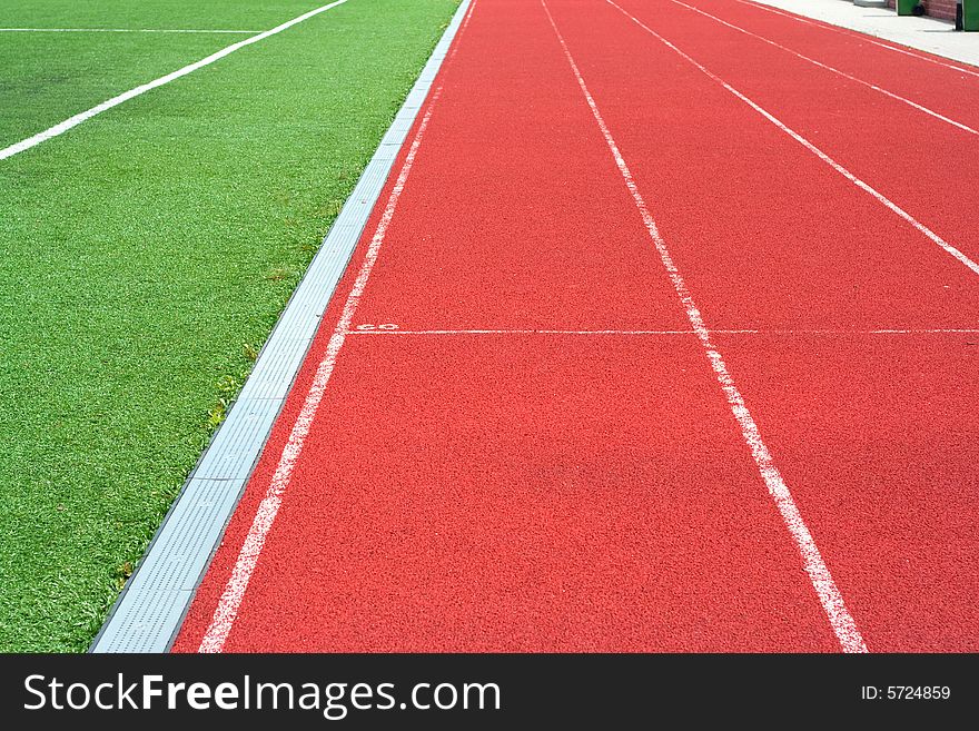 Red tartan athletic track on the stadium