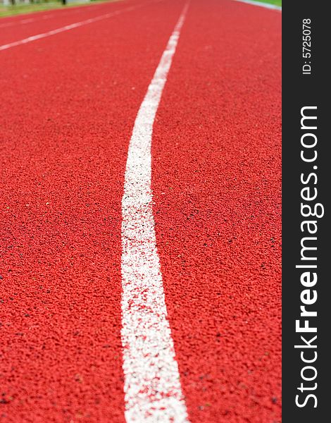 Red tartan athletic track on the stadium