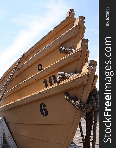 A stack of orange lifeboats on a dock