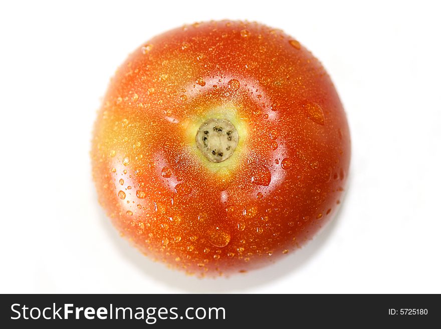 Top view of a red tomato with drops of water isolated on a white background. Top view of a red tomato with drops of water isolated on a white background.