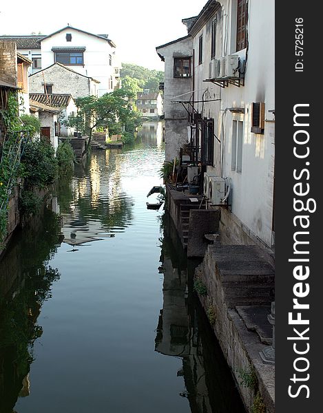 China, Zhejiang province, old town - Shaoxing with historical CanQiao street. Residential area is surrouded by water canals, which were water-roads for transportation in ancient times. Shaoxing is one of few watertowns in Zhejiang province. China, Zhejiang province, old town - Shaoxing with historical CanQiao street. Residential area is surrouded by water canals, which were water-roads for transportation in ancient times. Shaoxing is one of few watertowns in Zhejiang province.